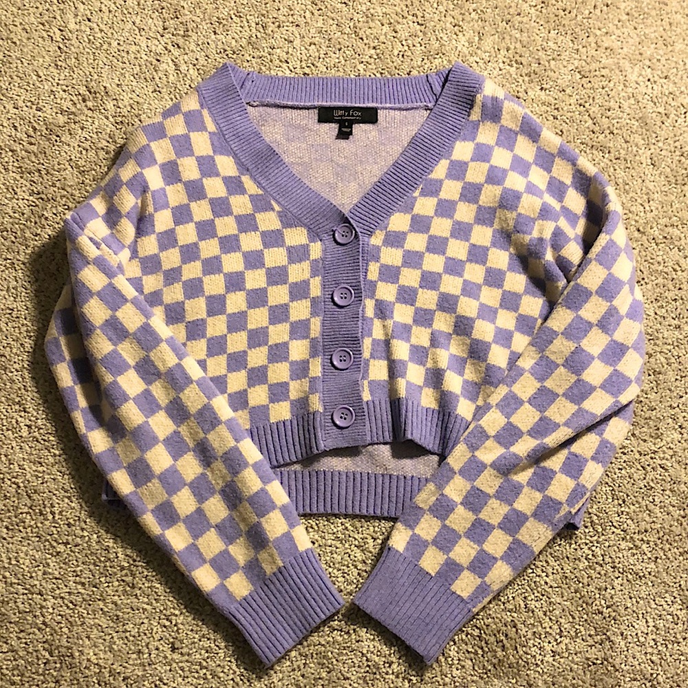 White and purple checkered sweater, cropped.